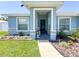 Inviting front porch with decorative accents, lush landscaping, and a welcoming entrance for added curb appeal at 2018 Misty Morning Dr, Winter Haven, FL 33880