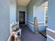 Charming covered front porch featuring blue walls and decorative elements creating a warm and inviting entryway space at 2018 Misty Morning Dr, Winter Haven, FL 33880
