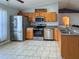 Kitchen with stainless steel appliances, oak cabinets, and tiled flooring at 2018 Misty Morning Dr, Winter Haven, FL 33880