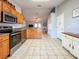 Open kitchen featuring stainless steel appliances and tile flooring at 2018 Misty Morning Dr, Winter Haven, FL 33880