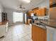 Bright kitchen featuring stainless appliances, oak cabinets and tile flooring at 2018 Misty Morning Dr, Winter Haven, FL 33880