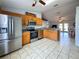 Kitchen featuring stainless appliances, wooden cabinetry, and an open layout at 2018 Misty Morning Dr, Winter Haven, FL 33880