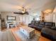 Open concept living room featuring wood flooring, a gray sectional and a decorative area rug at 2018 Misty Morning Dr, Winter Haven, FL 33880