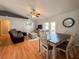 Open-concept living room and dining area with natural light and vaulted ceilings at 2018 Misty Morning Dr, Winter Haven, FL 33880
