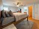 Comfortable main bedroom features hardwood floors, a bed, and an ensuite bathroom at 2018 Misty Morning Dr, Winter Haven, FL 33880