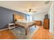 Main bedroom with hardwood floors, a ceiling fan, and a decorative rug at 2018 Misty Morning Dr, Winter Haven, FL 33880