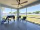 Screened-in patio with ceiling fan, view of yard, and outdoor seating at 2018 Misty Morning Dr, Winter Haven, FL 33880