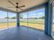 Spacious screened patio with a ceiling fan overlooking the fenced backyard at 2018 Misty Morning Dr, Winter Haven, FL 33880