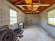 Interior of cinder block shed with windows, wood framing, and concrete floor at 2018 Misty Morning Dr, Winter Haven, FL 33880