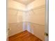 Walk-in closet with laminate flooring and wire shelving system at 2018 Misty Morning Dr, Winter Haven, FL 33880