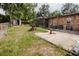 A spacious yard features a patio, storage shed, and lots of green space, all enclosed with a chain-link fence at 2213 W Pilaklakaha Ave, Auburndale, FL 33823