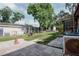 Large, grassy backyard includes a patio, shed, and mature trees offering ample space and privacy at 2213 W Pilaklakaha Ave, Auburndale, FL 33823