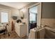 Bright bathroom with a walk-in tub, a vanity with storage, and neutral tile at 2213 W Pilaklakaha Ave, Auburndale, FL 33823