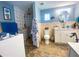 Well-lit bathroom with a walk-in shower, grab bars, and an accessible toilet at 2213 W Pilaklakaha Ave, Auburndale, FL 33823