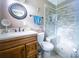 Tiled bathroom featuring a glass door shower at 2213 W Pilaklakaha Ave, Auburndale, FL 33823