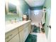 Bathroom with large mirror and bright turquoise walls at 2213 W Pilaklakaha Ave, Auburndale, FL 33823