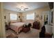 Cozy bedroom features a ceiling fan, with natural light from the windows and light colored walls at 2213 W Pilaklakaha Ave, Auburndale, FL 33823