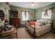 Bedroom with light green walls and lots of decor at 2213 W Pilaklakaha Ave, Auburndale, FL 33823