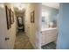 Hallway leading to bathroom with double sink at 2213 W Pilaklakaha Ave, Auburndale, FL 33823
