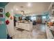 Spacious kitchen features white cabinets, a kitchen island with seating, and a view of the dining area at 2213 W Pilaklakaha Ave, Auburndale, FL 33823