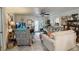Bright living room featuring neutral walls, ceiling fan and tile floors at 2213 W Pilaklakaha Ave, Auburndale, FL 33823