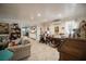 Cozy living room adjacent to the kitchen and dining area with hardwood floors and neutral paint at 2213 W Pilaklakaha Ave, Auburndale, FL 33823