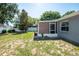 Backyard with a screened-in patio, offering a comfortable outdoor living space at 2240 Country Manor St, Bartow, FL 33830