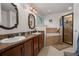 Bathroom featuring dual sinks, granite countertops, a soaking tub, and a tiled shower at 2240 Country Manor St, Bartow, FL 33830
