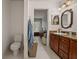 Bathroom with single vanity with granite countertop and blue accents, leading to a bedroom at 2240 Country Manor St, Bartow, FL 33830