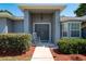 Inviting front entrance with a cozy rocking chair and manicured landscaping at 2240 Country Manor St, Bartow, FL 33830