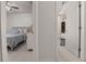 Hallway view showcasing access to a bedroom and a bathroom with white marble tiled floors at 2240 Country Manor St, Bartow, FL 33830
