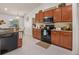 Practical kitchen featuring dark wood cabinets, stainless steel appliances, and tile backsplash at 2240 Country Manor St, Bartow, FL 33830