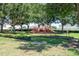 Playground with trees offers a fun and shaded area for children to play at 2240 Country Manor St, Bartow, FL 33830