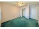 Cozy bedroom with green carpet, ceiling fan, and ample closet space at 254 Winter Ridge Blvd # 254, Winter Haven, FL 33881