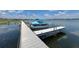 Community dock on the lake with boat slips and a boat at 254 Winter Ridge Blvd # 254, Winter Haven, FL 33881