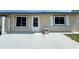 Charming single-story home with a welcoming front entrance and neutral-colored exterior with a concrete patio at 254 Winter Ridge Blvd # 254, Winter Haven, FL 33881