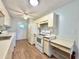 Efficient kitchen featuring white appliances, countertop, ample storage and laundry appliances at 254 Winter Ridge Blvd # 254, Winter Haven, FL 33881