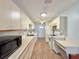 Well-lit kitchen with white cabinets, modern appliances, ample countertop space, and wood-look flooring at 254 Winter Ridge Blvd # 254, Winter Haven, FL 33881
