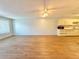 Open and airy living room featuring wood floors, natural lighting, and an adjacent kitchen space at 254 Winter Ridge Blvd # 254, Winter Haven, FL 33881