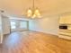 Open living space featuring wood floors, neutral walls, and a modern light fixture over a living space at 254 Winter Ridge Blvd # 254, Winter Haven, FL 33881