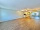 Bright and airy living room featuring hardwood floors, a ceiling fan, and a seamless flow into the kitchen at 254 Winter Ridge Blvd # 254, Winter Haven, FL 33881