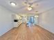 Open floor plan with ceiling fan connecting the living room, dining area, and kitchen space at 254 Winter Ridge Blvd # 254, Winter Haven, FL 33881
