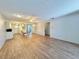Spacious living area with open-concept design, wood floors, ceiling fan, and seamless flow to the kitchen at 254 Winter Ridge Blvd # 254, Winter Haven, FL 33881