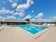 Enjoy the community pool featuring lounge chairs and clear blue water on a sunny day at 254 Winter Ridge Blvd # 254, Winter Haven, FL 33881
