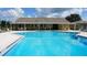 Community pool with lounge chairs and a covered pavilion at 254 Winter Ridge Blvd # 254, Winter Haven, FL 33881