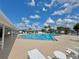 The sparkling blue community pool offers lounge chairs and mature trees, perfect for relaxation at 254 Winter Ridge Blvd # 254, Winter Haven, FL 33881