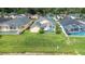 Aerial view of the rear of the home featuring screened in pool and green lawn at 263 Reserve Dr, Davenport, FL 33896