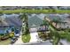 Aerial view of a home with a well-manicured lawn, screened-in pool, and lush landscaping at 263 Reserve Dr, Davenport, FL 33896