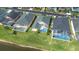 Aerial view of homes with screened-in pools in a scenic community with waterfront views at 263 Reserve Dr, Davenport, FL 33896