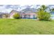Well-maintained backyard with screened-in pool and lush green lawn, ideal for outdoor activities at 263 Reserve Dr, Davenport, FL 33896